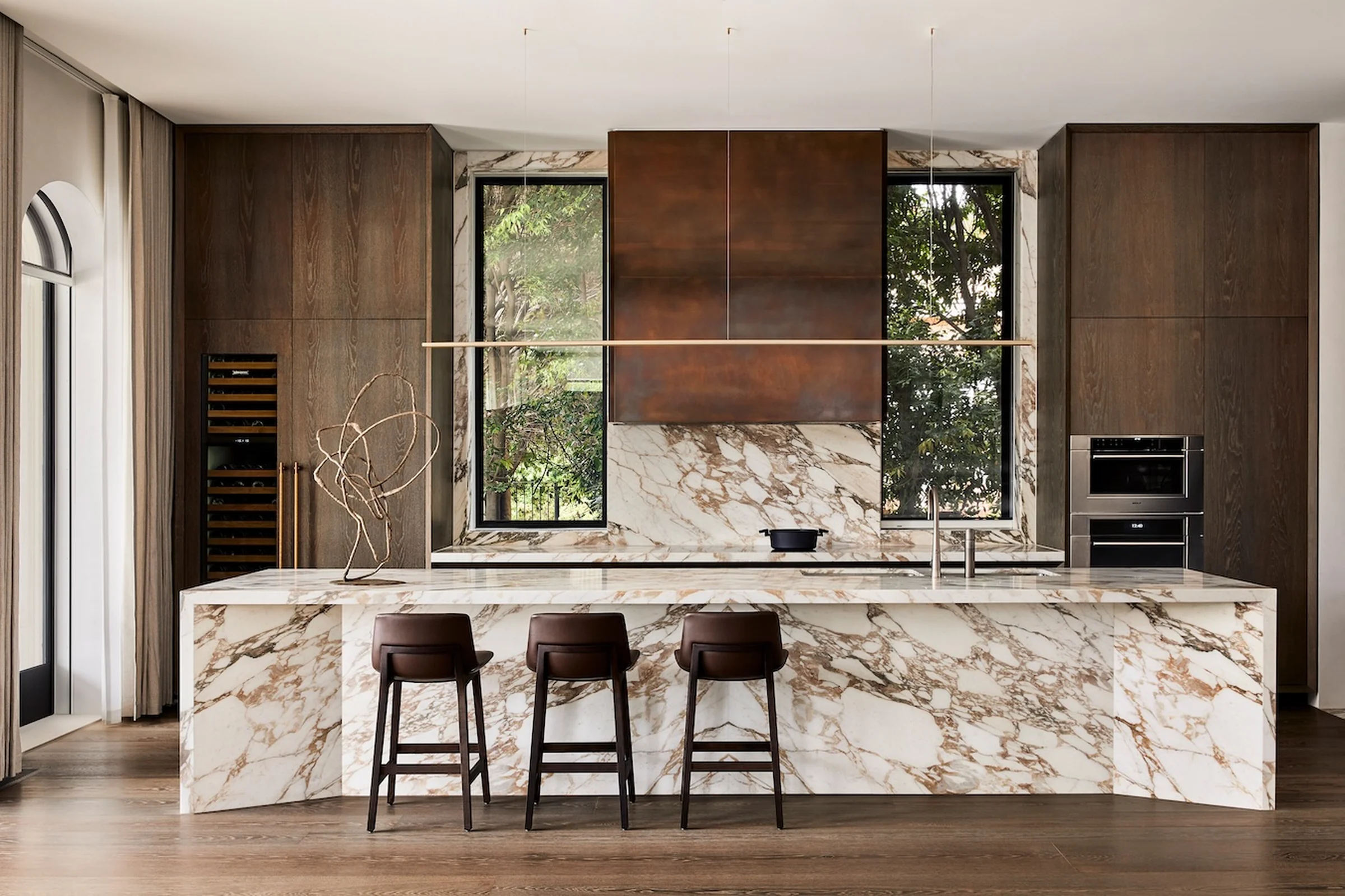 Light stone kitchen countertops with a matching full-height backsplash.