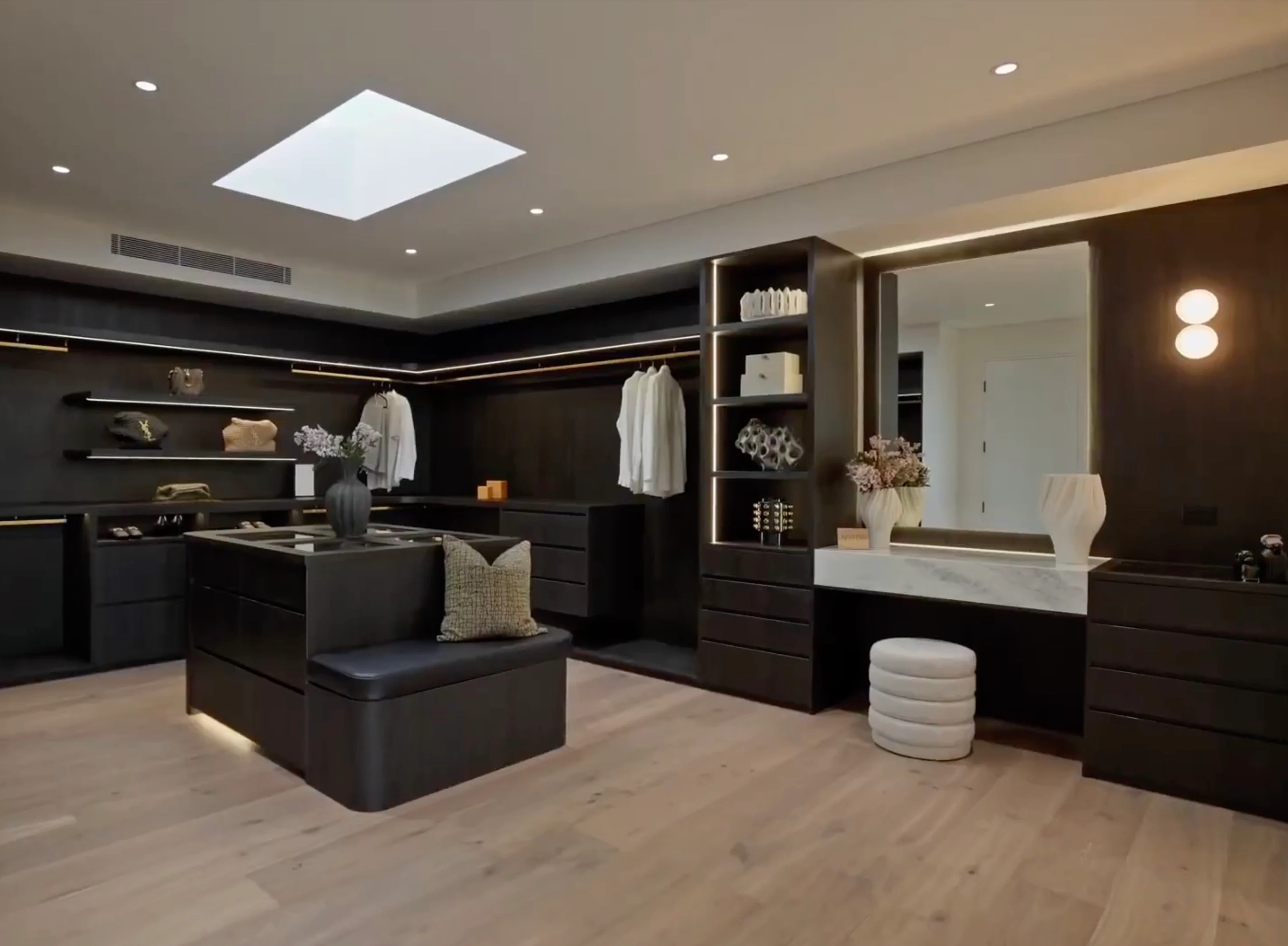 Open fitted wardrobe with shelves, drawers and hanging rails.